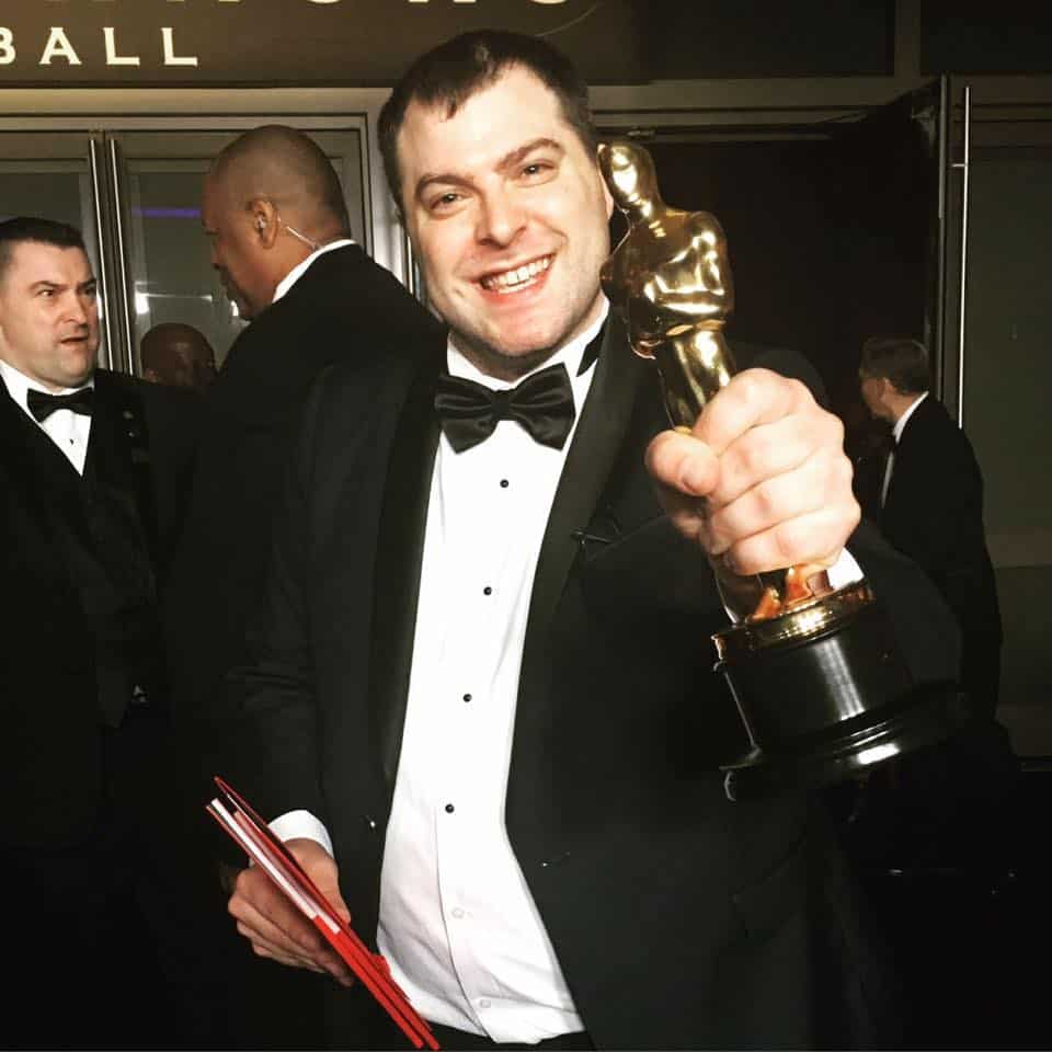 Andrew Carlberg Holding his Oscar